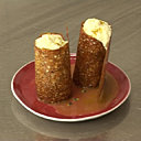 Dans un tube de caramel cassant et croustillant, un minestrone de fruits exotiques frais, surmonté d'une émulsion siphonnée au lait de coco et curry.