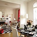 Sur une table Philippe Hurel, sets, serviettes, bougeoirs, flûtes, Potiron, assiettes noires, couverts, Ikéa, assiettes style « Pompadour », La Chaise Longue, plats « cartes à jouer », Galeries Lafayette Maison (marque mirage) ; lampe en papier, Isamu Nogushi, Sentou galerie.