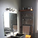 Les miroirs aux angles arrondis ont été réalisés sur mesure; 2 grands sèche-serviettes mixtes chromés ont été installés, Bebop de Delonghi