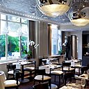 Vue sur un jardin clos, calme absolu pour une table qui se prête élégamment à des déjeuners d'affaires ou dîners feutrés.