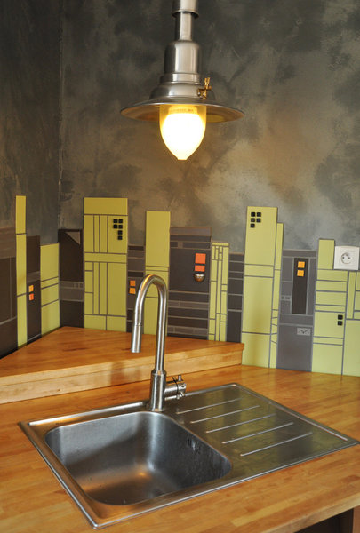 Fresque contemporaine alliant la qualité des matériaux, le design et le côté fonctionnel d' une cuisine résolument moderne