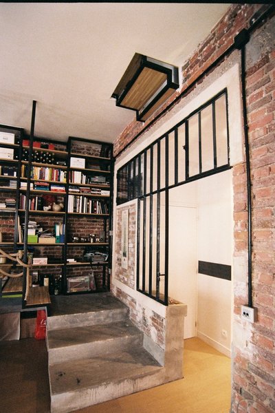 Au premier niveau, les cloisons intérieures d’origine ont été dotées de nouvelles fenêtres façon atelier pour faire entrer la lumière. Les murs en brique ont été remis à nu et les matériaux bruts comme le béton, en masse ou enduit a été mis en valeur