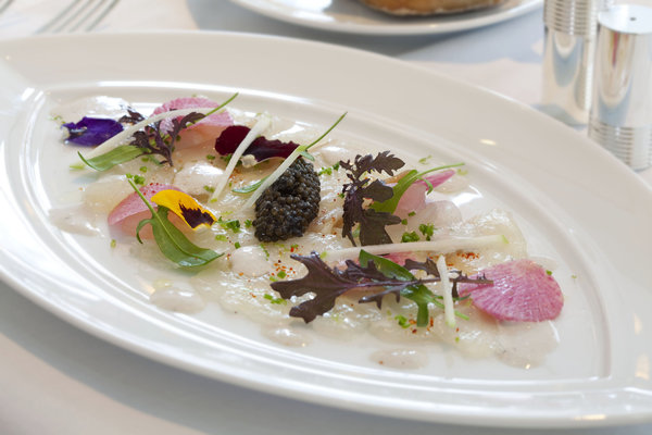 Le bar de ligne en fin carpaccio, crème d’huître au caviar impérial de France, radis “Red Meat” et granny smith au citron vert.
