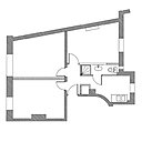 Une salle de bains greffée maladroitement dans la cuisine, dans un espace double fonction de seulement 9 m².