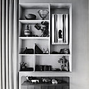 Dans la maison de la via Dezza, loin des rayonnages linéaires standardisés, un modèle de bibliothèque ludique doté d’un petit miroir. Jeu de géométriques, ses casiers et niches offrent un espace de rangement dynamique et rythmé, qui s’adapte aux objets décoratifs comme aux livres.