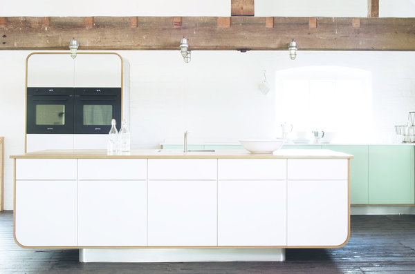 Le Hi-Macs habille cette cuisine contemporaine made in Italie. Les courbes de l’îlot, du plan de travail, et de la table sont fluides, les teintes noires et blanches inspirent une ambiance japonisante, très « yin et yang ». (Cuisine It-is par Euromobil, design de Simone Micheli - Hi-Macs Alpine White).