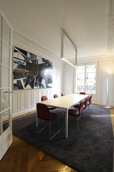 Le volume de la salle à manger n’a pas changé, mais l’espace est métamorphosé par le mobilier. Tous les éléments anciens d’architecture intérieure sont mis en valeur par le choix du design. Le parquet en point de Hongrie, la partie basse des murs animés de cadres moulurés et les corniches remplissent l’espace de leur élégante présence.