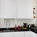 Les rangements ont été composés à partir de placards standards (Ikea), redécoupés pour s’adapter parfaitement à l’espace. La cuisine joue l’effet de contraste extrême entre les façades laquées et immaculées des meubles de la cuisine et le plan de travail très sombre. Un bel espace graphique et bicolore !