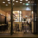 La vitrine s’ouvre entièrement vers l’extérieur sur un petit espace qui fait office de terrasse aux beaux jours.