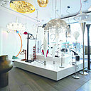 Dans sa nouvelle boutique, Christos Sapranides a rassemblé ses deux passions : l’art contemporain et les luminaires. Il a imaginé un décor façon galerie d’art, où les luminaires sont exposés à la vente, tels de véritables œuvres d’art.