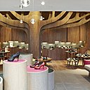 En menant à bien le projet Bocage, Eric Gizard a donné une véritable identité à la marque. Dans les boutiques à l’architecture nordique, un arbre en plaqué occupe une place centrale, sous lequel on s’assoit pour essayer les chaussures. Au plafond, des boules en verre apportent une touche féerique. Des touches de couleurs, changeantes au fil des saisons, rythment l’espace.