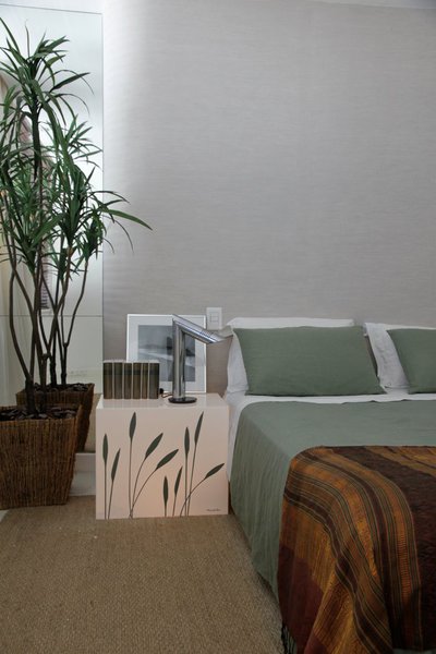 Table lumineuse créée par House in Rio Projects pour cette chambre. Tapis en sisal et mur de tête de lit revêtu de lin.