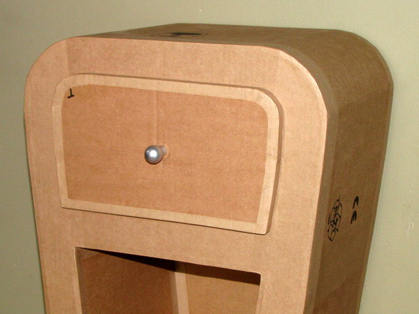 Etape 27. Percez un trou au centre du tiroir, grâce à la vrille de 3 mm. Fixez une poignée, en intercalant une rondelle métallique large, entre la vis de la poignée, et le tiroir, afin de répartir la force. La rondelle est placée à l’intérieur du tiroir.