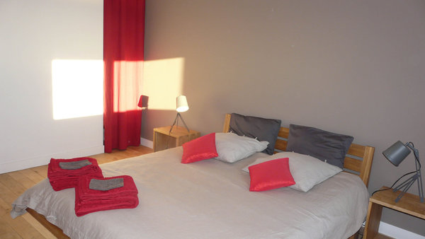 La décoration des chambres d’hôtes fait la part belle à la couleur rouge, qui met en valeur le bois omniprésent.