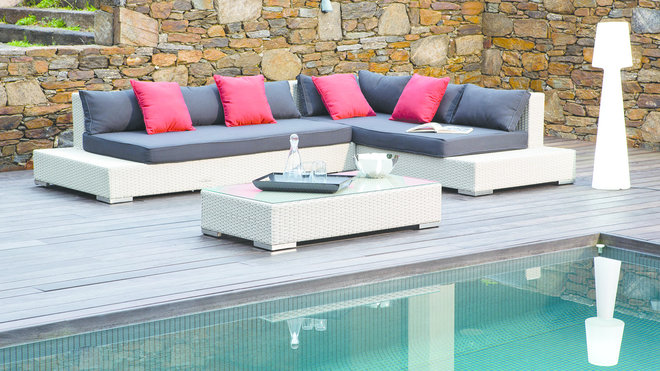 Confortable. Salon, Asella, structure en aluminium, résine tressée, coussins d’assise et de dossier en polyester enduit, plateau en verre, Ermanno G, 959 €.