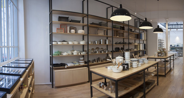 Strict et rationnel, l’aménagement réalisé avec de hautes étagères et de grandes tables rappelle les anciens bazars où l’on trouvait de tout.