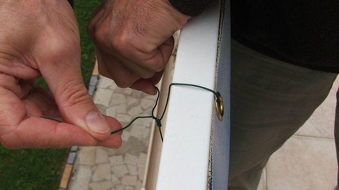 Etape 3 : La fixation du brise-vue déco sera effectuée au travers des œillets, posés sur le brise-vue préalablement à la commande,  à l’aide de fil de fer souple. Bien tendre le fil en serrant et en entourant les extrémités du fil souple.