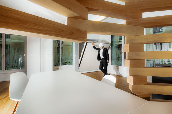 Une table en porte-à faux dessine l’espace repas. Tandis qu’un lit d’appoint escamotable est camouflé dans les rangements muraux.