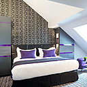 Ambiance des chambres  Grey Pourpre au mélange poudré de gris de lin et de gris tourterelle rehaussé d'un purple profond et chaleureux.