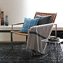 Installée à la base des stores, cette grande tablette qui court de mur à mur permet de poser de beaux objets qui joueront avec la lumière. Des boîtes de rangement, choisies dans la même couleur, se glissent discrètement sous l’étagère.