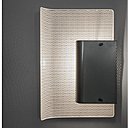 Applique 224, composée de deux feuilles en métal dont l’une perforée laisse passer la lumière à travers une sorte de filtre. Création de Jacques Biny.