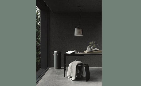 Un coin bureau est aménagé dans le séjour. Le noir est de rigueur et laisse place à l’ouverture sur la nature avec un sol en béton allégé.