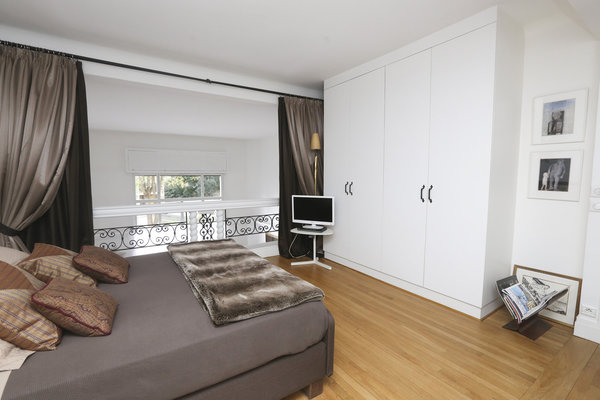 Le lit peut être occulté par des rideaux, et des placards intégrés ont été prévus pour le rangement.