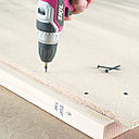 Etape 6 : fixez les panneaux derrière les deux structures latérales que vous avez réalisées à l’étape 4. Posez la structure sur le panneau de façon à l’aligner avec le bord inférieur et le bord arrière, en laissant dépasser une longueur de 3,81 cm du panneau de particules en haut et une longueur de 2 cm du tasseau de 38 mm x 89 mm sur le devant. Placez les vis aux quatre coins et au milieu de chaque côté de votre structure.