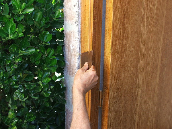 Etape 15 : Terminer le travail d’imitation en passant le peigne en acier à faux bois sur le bâti de la porte. Laisser sécher de 12 heures à 24 heures, puis passer deux couches de vernis glycérophtalique d’aspect brillant ou satiné.