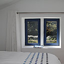 Au premier étage de l’ancienne maison, comme au rez-de-chaussée, les menuiseries en aluminium bleu prussien mettent en valeur les ouvertures.