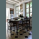 Au rez-de-chaussée, la pièce à vivre, ouverte sur le jardin présente une table ancienne, et autour, les chaises Superleggera de Gio Ponti de 1951. Au rez-de-chaussée, la pièce à vivre, ouverte sur le jardin présente une table ancienne, et autour, les chaises Superleggera de Gio Ponti de 1951.