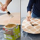 Etape 7 : appliquez ensuite une première couche de vernis incolore sur l’ensemble de l’assise, et laissez sécher 2 heures. Après séchage, posez des rubans adhésifs sur l’assise pour former un quadrillage qui modernisera votre siège. Appliquez au pinceau le vernis de la couleur de votre choix (ici, couleur ébène) en suivant toujours le sens des veines du bois.