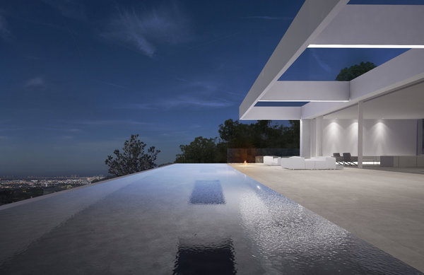 L’eau de la piscine affleure la terrasse offrant l’effet d’une plage.