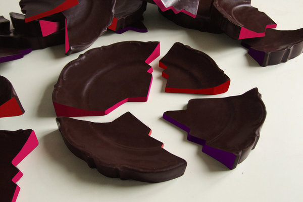 Assiette cassée, en chocolat brisé, antidépresseur et euphorisant. Chocolat noir pur Madagascar, cerise séchée, noir Sao tome, noir Americao 72 %, fève de tonka, poivre de Selim, piments, gingembre frais râpé et séché…Chaque brisure d’assiette se distingue des autres par une couleur et une saveur différentes. Création Delphine Huguet.