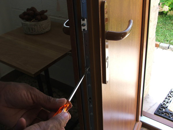 Etape 1 : retirer la vis de fixation du cylindre située sur le chant de la porte.