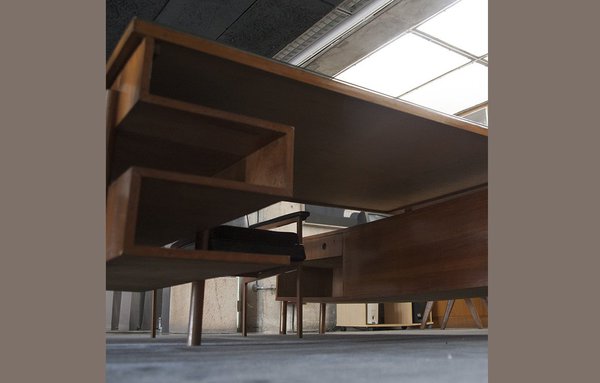 Bureau administratif démontable en teck massif et placage de teck dit « Snake » avec épais plateau rectangulaire plaqué reposant sur deux caissons double face dont un long et un court, les deux suspendus à des pieds de type « rondin ». Création Pierre Jeanneret. Modèle vers 1957-58.
