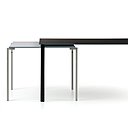 Table 1=2 est un principe de deux éléments, table de salle à manger et console qui se chevauchent. Plateau en verre trempé et piètement en acier inoxydable. Création Jean Nouvel pour Cassina, en 1999, réédition en 2013.