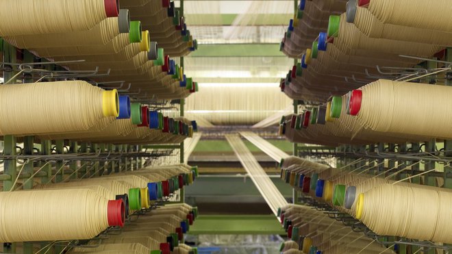 L’entreprise Vincent Sheppard maîtrise tout le processus de production. Les bobines du fameux fil métallique enroulé de papier kraft sont prêtes pour le tissage du Lloyd Loom.