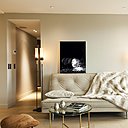 Dans le séjour, de part et d’autre du canapé, on a pratiqué une double circulation et supprimé les portes encombrantes. A gauche, on accède à la cuisine. A droite, on rentre dans la chambre. Canapé Ligne Roset. Lampadaires et tabourets, Galerie Yves Royer. Table basse, Cassina. Au dessus du canapé, une photo de Sébastien Patron.
