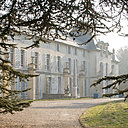 Dans son écrin naturel, la bâtisse à laquelle on accède par une avenue bordée de grands arbres. Ici, sa façade principale sur les jardins, avec au premier plan les branches du cèdre de Marengo.