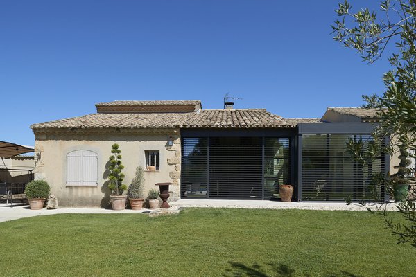 L’extension se compose de grandes baies coulissantes Soleal qui prennent appui sur l’avancée de toit de l’ancienne terrasse. Elles ouvrent le salon sur l’extérieur et permettent aux occupants de profiter de la vue sur le jardin, été comme hiver.