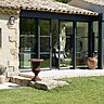 La finesse des profilés et leur couleur « noir sablé » contribuent à l’effacement des ouvertures. Cette esthétique minimaliste, associée aux traverses horizontales, confère un style contemporain à la bâtisse provençale.