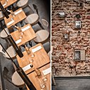 Les suspensions ont été créées en exclusivité pour le restaurant ; le mur en brique est ponctué de photos noir et blanc en référence au restaurant l’Air du temps.