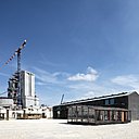A droite, la  Maison des jours meilleurs (1956) commandée par l’abbé Pierre, fondateur des Compagnons d’Emmaüs. D’une surface de 57m², montée en 7 heures, elle a été jugée trop révolutionnaire pour son époque. Elle n’a pas obtenu les homologations officielles pour une production en série. Les fonctionnaires refusaient notamment qu’une salle d’eau soit installée au cœur de l’habitation. Ce refus a entraîné l’arrêt définitif du projet et sa production industrielle. Seuls quelques exemplaires ont été réalisés.