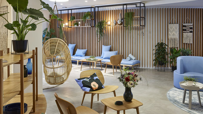 Une ambiance de jardin intérieur qui met à l’honneur les matériaux naturels. Bouquet champêtre, création Amandine Maziers pour Haut les cœurs. Coussin, Marimekko. Siège balancelle, modèle Renoir Swing en Alu-rotin chez Sika Design.