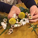 Les fleurs et végétaux se fixent par une simple ligature autour d'une tige de lierre.