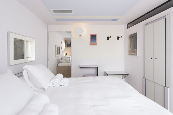 Placards muraux cachant la salle de bains et nombreux miroirs pour agrandir l’espace dans la chambre 12 imaginée par Valentina Cameranesi et Enrico Pompili.