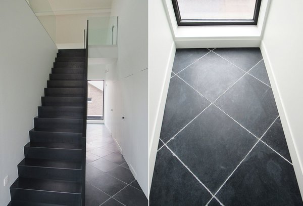 Les zones de circulation ont été traitées pierre naturelle sombre. La pose en diagonale agrandit le couloir.