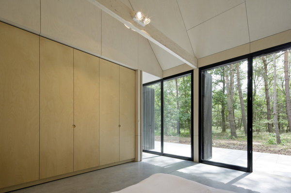 Les espaces de vie s’ouvrent largement sur la forêt grâce à une façade entièrement vitrée.