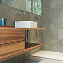 Douche à l’italienne et long meuble vasque intégré qui fait gagner de la place dans la salle de bains.